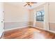 Bright bedroom featuring wood floors, a ceiling fan and natural light from a window at 12649 Dallington Ter, Winter Garden, FL 34787