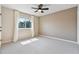 Bright bedroom with neutral carpet, ceiling fan, and large window with curtains at 12649 Dallington Ter, Winter Garden, FL 34787