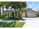 Charming two-story home features mature landscaping, a three-car garage, and a brick driveway at 12649 Dallington Ter, Winter Garden, FL 34787