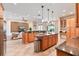 Large kitchen with two islands, wood cabinets, stainless steel appliances, and tile floors at 12649 Dallington Ter, Winter Garden, FL 34787