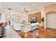 Bright living room with hardwood floors and neutral decor extends into bar area and kitchen at 12649 Dallington Ter, Winter Garden, FL 34787