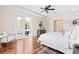 Bright main bedroom boasts hardwood floors, tray ceiling, and access to outdoor patio at 12649 Dallington Ter, Winter Garden, FL 34787