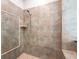 Walk-in shower with a shower head and neutral-colored tiles at 12649 Dallington Ter, Winter Garden, FL 34787