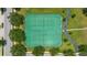 An aerial shot features pristine tennis courts surrounded by lush greenery at 12649 Dallington Ter, Winter Garden, FL 34787