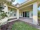 A covered brick patio outside sliding glass doors, offering a serene outdoor living space at 13065 Gabor Ave, Orlando, FL 32827