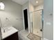 Well-lit bathroom with a glass shower, a dark wood vanity, and tile flooring at 13065 Gabor Ave, Orlando, FL 32827