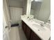 Bathroom featuring double sinks, a large mirror and a shower/tub combo at 13065 Gabor Ave, Orlando, FL 32827