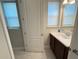 Bathroom featuring a double sink vanity, tiled floor, and ample lighting for a refreshing experience at 13065 Gabor Ave, Orlando, FL 32827