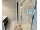 Modern bathroom features a glass-enclosed shower, sleek vanity, and neutral tile flooring at 13065 Gabor Ave, Orlando, FL 32827