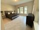 Cozy bedroom with tile floors, three windows offering natural light, and comfortable furnishings at 13065 Gabor Ave, Orlando, FL 32827