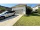 Exterior view of the home showcasing the garage and driveway at 13065 Gabor Ave, Orlando, FL 32827