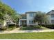 Charming two-story home featuring a balcony, a manicured lawn and lush landscaping at 13065 Gabor Ave, Orlando, FL 32827