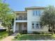 Charming two-story home featuring a balcony, a manicured lawn and lush landscaping at 13065 Gabor Ave, Orlando, FL 32827