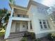 Charming two-story home featuring a balcony, a manicured lawn and lush landscaping at 13065 Gabor Ave, Orlando, FL 32827