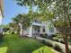 Charming two-story home featuring a balcony, a manicured lawn and lush landscaping at 13065 Gabor Ave, Orlando, FL 32827