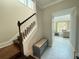 Elegant foyer features tiled floors, wooden staircase, and access to the living room at 13065 Gabor Ave, Orlando, FL 32827