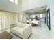 Open-concept living room and dining area with neutral color palette and lots of natural light at 13065 Gabor Ave, Orlando, FL 32827