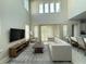 Bright living room with soaring ceilings, large windows, neutral decor and lots of natural light at 13065 Gabor Ave, Orlando, FL 32827