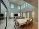 Bright living room boasts high ceilings, many windows, and a large dining table at 13065 Gabor Ave, Orlando, FL 32827
