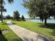 Scenic view of the community pond and surrounding lush landscaping with walking path at 13065 Gabor Ave, Orlando, FL 32827