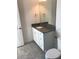 Bathroom featuring granite countertop, white cabinets, and modern fixtures at 13885 Arclid St, Orlando, FL 32832