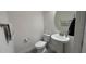 Clean powder room features a pedestal sink, round mirror, and modern fixtures at 13885 Arclid St, Orlando, FL 32832