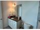 Bathroom features a granite countertop, white cabinets, and modern fixtures at 13885 Arclid St, Orlando, FL 32832