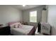 Bright bedroom with a pink bed, large window, and ample natural light creates a cozy atmosphere at 13885 Arclid St, Orlando, FL 32832