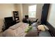 Comfortable bedroom with a window for natural light, furnished with a desk and shelving at 13885 Arclid St, Orlando, FL 32832