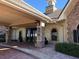 Beautiful clubhouse exterior with stone accents, covered entrance, clock tower, and well-maintained landscaping at 13885 Arclid St, Orlando, FL 32832