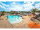 Gathering-friendly community pool area with splash features and ample lounge seating under a sunny sky at 13885 Arclid St, Orlando, FL 32832