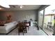 This view showcases the dining area with a wood table and chairs adjacent to the living room at 13885 Arclid St, Orlando, FL 32832
