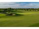 Expansive golf course showcasing meticulously maintained greens, challenging sand traps, and picturesque landscaping at 13885 Arclid St, Orlando, FL 32832