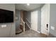 View of the hallway with stairs to the upper level, a front door, and neutral paint colors at 13885 Arclid St, Orlando, FL 32832