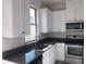Close-up of a modern kitchen featuring granite countertops and stainless steel appliances at 13885 Arclid St, Orlando, FL 32832