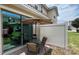 Cozy backyard patio features a round table, umbrella, and privacy fence, perfect for outdoor dining at 13885 Arclid St, Orlando, FL 32832