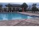 A large community pool awaits with lounge chairs and tables available for residents to enjoy poolside at 13885 Arclid St, Orlando, FL 32832