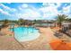 Enjoy the community pool with splash pad, lounge chairs, and tables with umbrellas on a sunny day at 13885 Arclid St, Orlando, FL 32832
