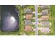 Great aerial view of backyards of homes backing on to pond and street at 142 Olympus Way, Kissimmee, FL 34759