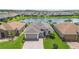 Beautiful aerial view of the property with well manicured lawn and pond in the background at 142 Olympus Way, Kissimmee, FL 34759