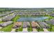 Incredible aerial view of houses with ponds and a blue sky filled with clouds at 142 Olympus Way, Kissimmee, FL 34759