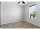 Comfortable bedroom with wood-look tile flooring, bright natural light and relaxing ceiling fan at 142 Olympus Way, Kissimmee, FL 34759