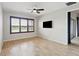 Bedroom features wood-look tile flooring, a ceiling fan, and natural light; a relaxing retreat at 142 Olympus Way, Kissimmee, FL 34759