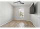 Bedroom featuring ceiling fan, wood-look tile and a mounted TV; a relaxing space at 142 Olympus Way, Kissimmee, FL 34759