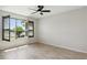 Cozy bedroom featuring natural light, a ceiling fan, and stylish window shutters; a serene space at 142 Olympus Way, Kissimmee, FL 34759