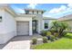 Inviting home entrance, showcasing the front door, lush greenery, and a neat brick walkway at 142 Olympus Way, Kissimmee, FL 34759