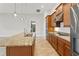 Gourmet kitchen with granite counters, stainless steel appliances, and a large center island at 142 Olympus Way, Kissimmee, FL 34759