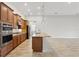Modern kitchen features granite countertops, stainless appliances, wood cabinets and a center island at 142 Olympus Way, Kissimmee, FL 34759