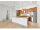 Modern kitchen with stainless steel appliances, granite countertops, and wood cabinets at 142 Olympus Way, Kissimmee, FL 34759
