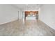 Expansive living room features wood-look tile flooring, offering a bright and airy space for relaxation at 142 Olympus Way, Kissimmee, FL 34759